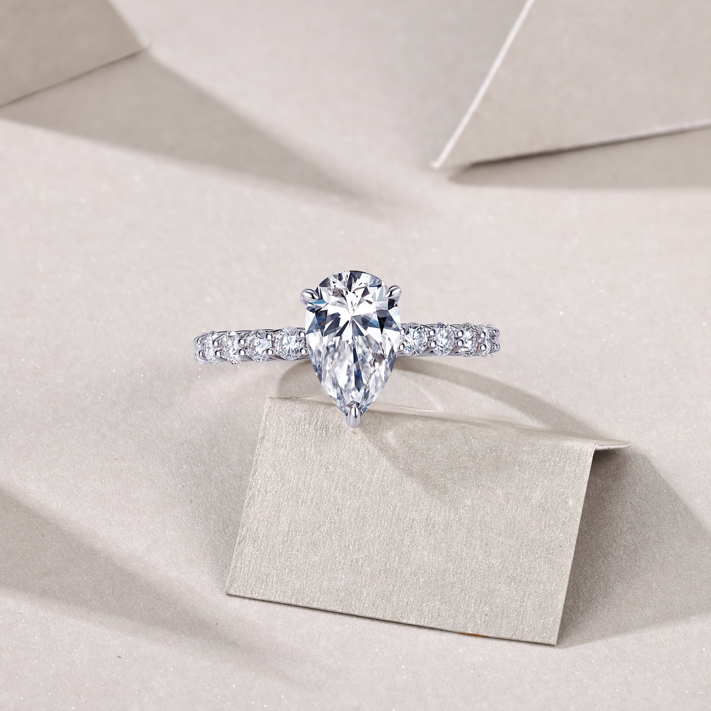 An eco-friendly diamond ring set with pear-shaped Moissanite S925 sterling silver plated with platinum