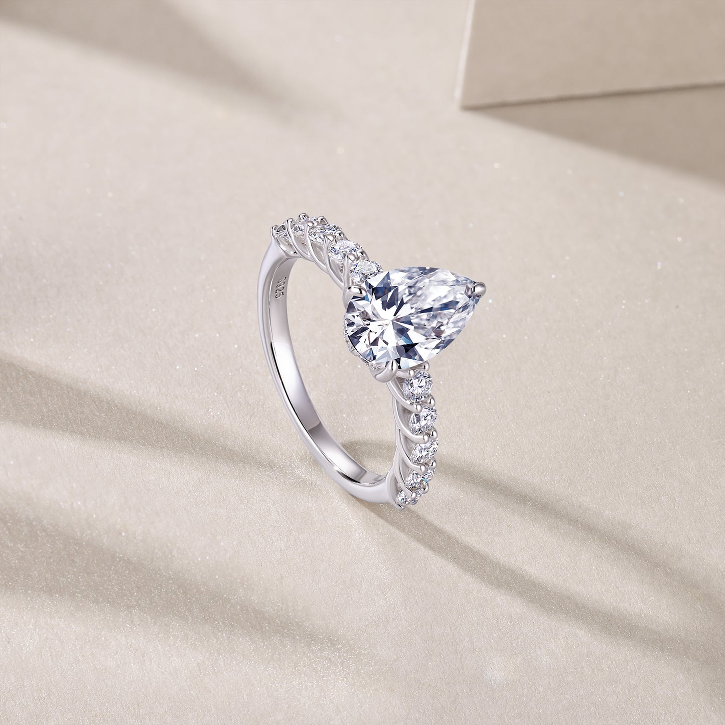 An eco-friendly diamond ring set with pear-shaped Moissanite S925 sterling silver plated with platinum