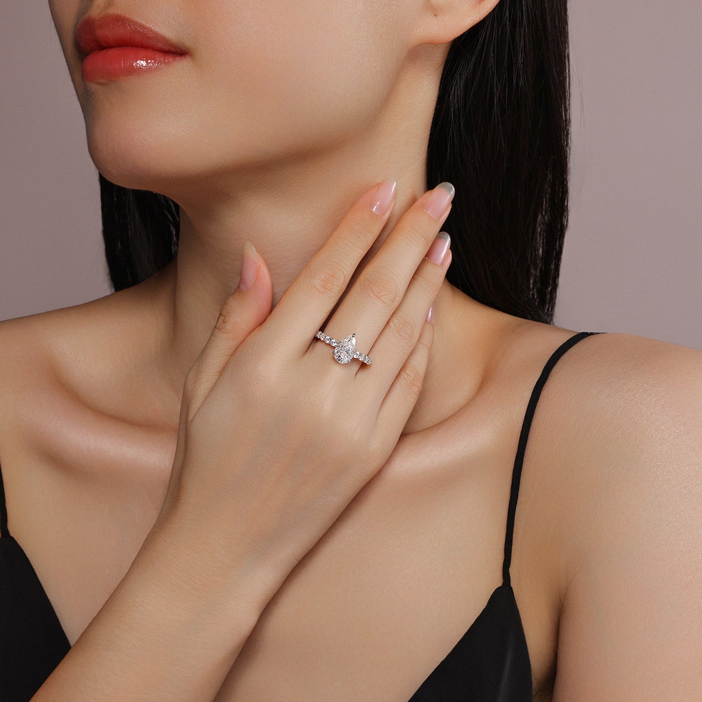 An eco-friendly diamond ring set with pear-shaped Moissanite S925 sterling silver plated with platinum